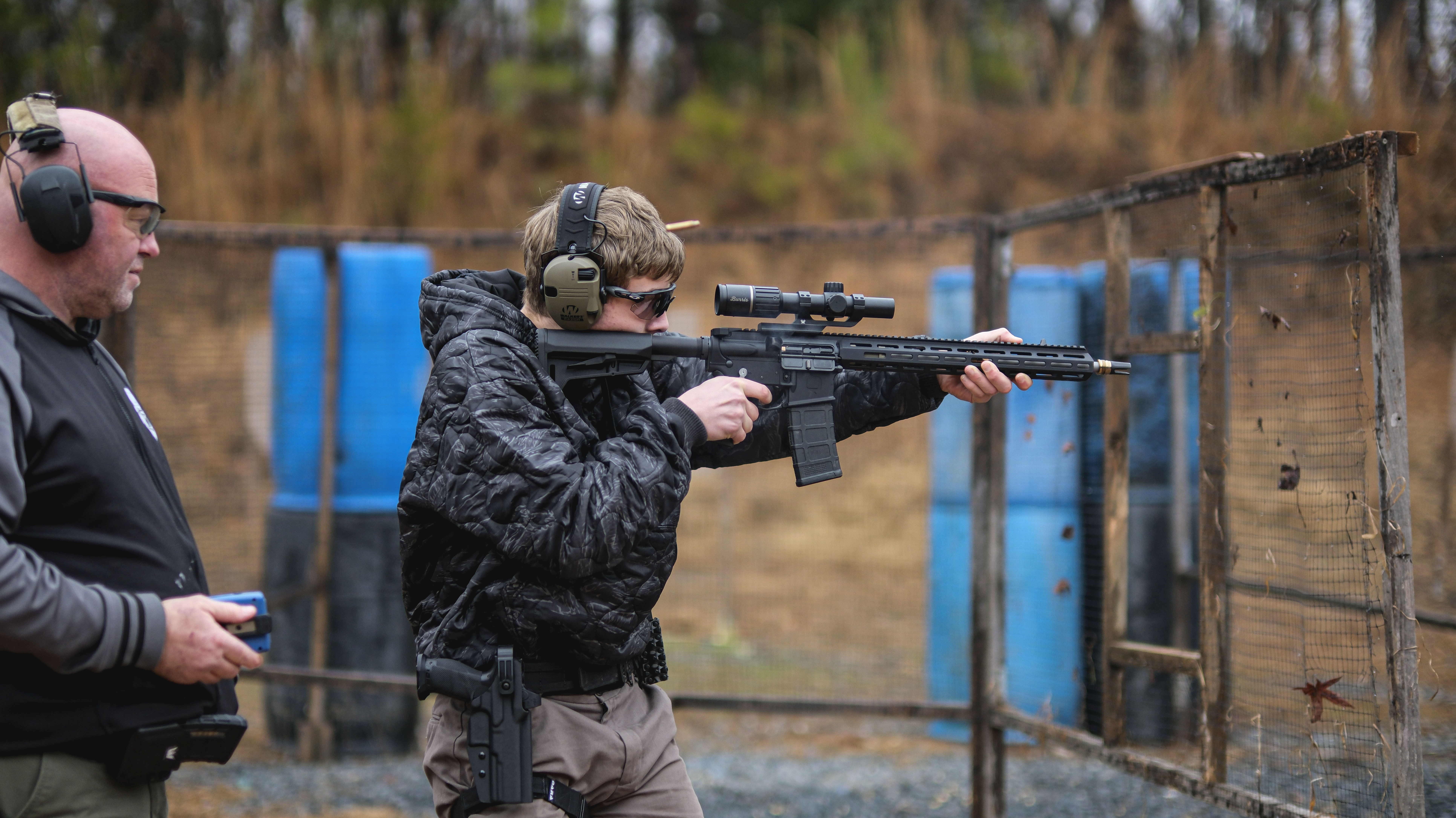 Axel Dara shooting competition action picture with drop offset holster